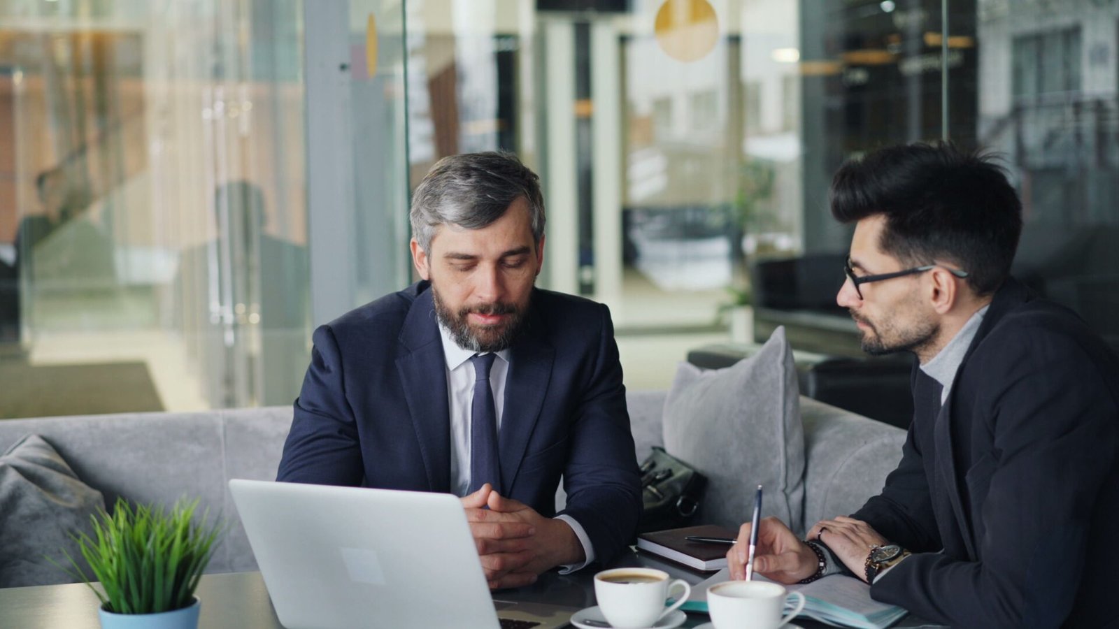 Business leaders discussing transformation strategy over coffee