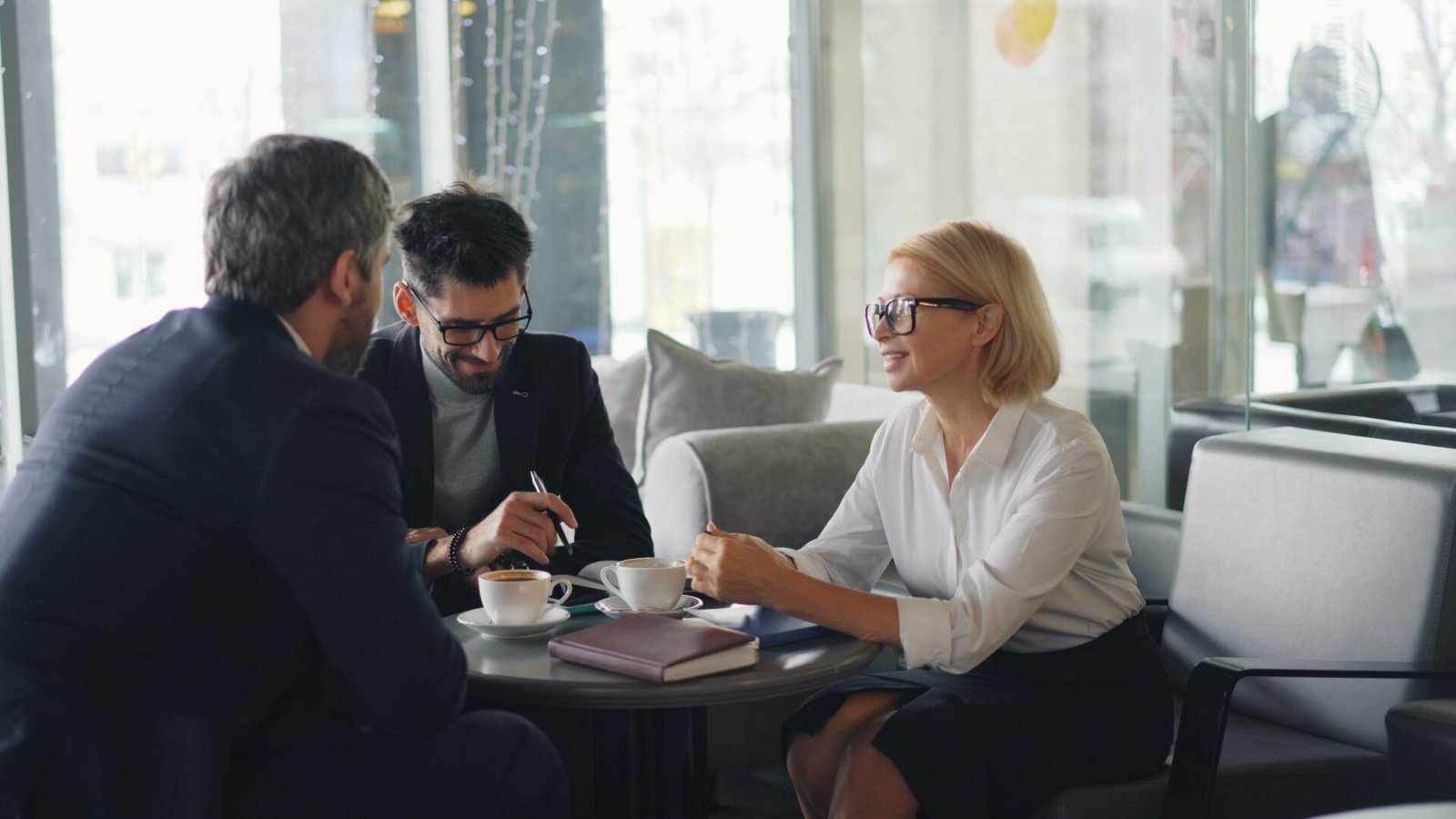 Business consultants discussing strategy at a cafe meeting