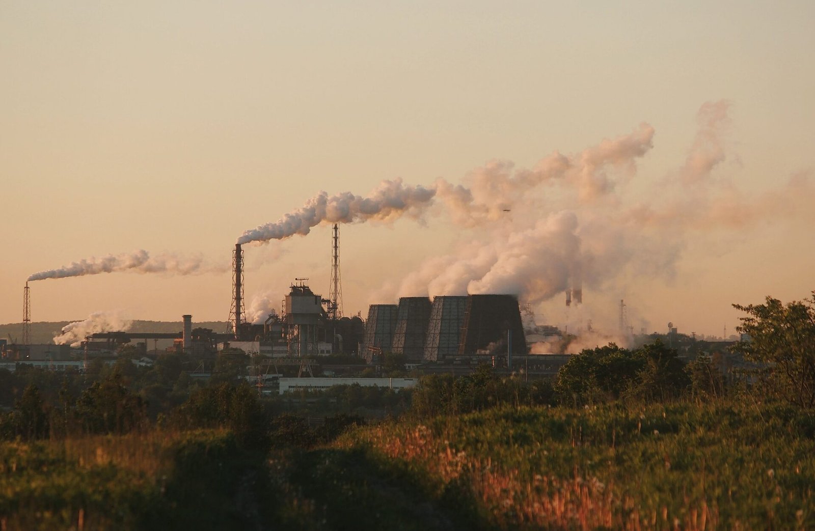 ESG Consulting Nepal %corporate custom e-learning training agency% Factory chimneys releasing industrial smoke, symbolizing environmental impact