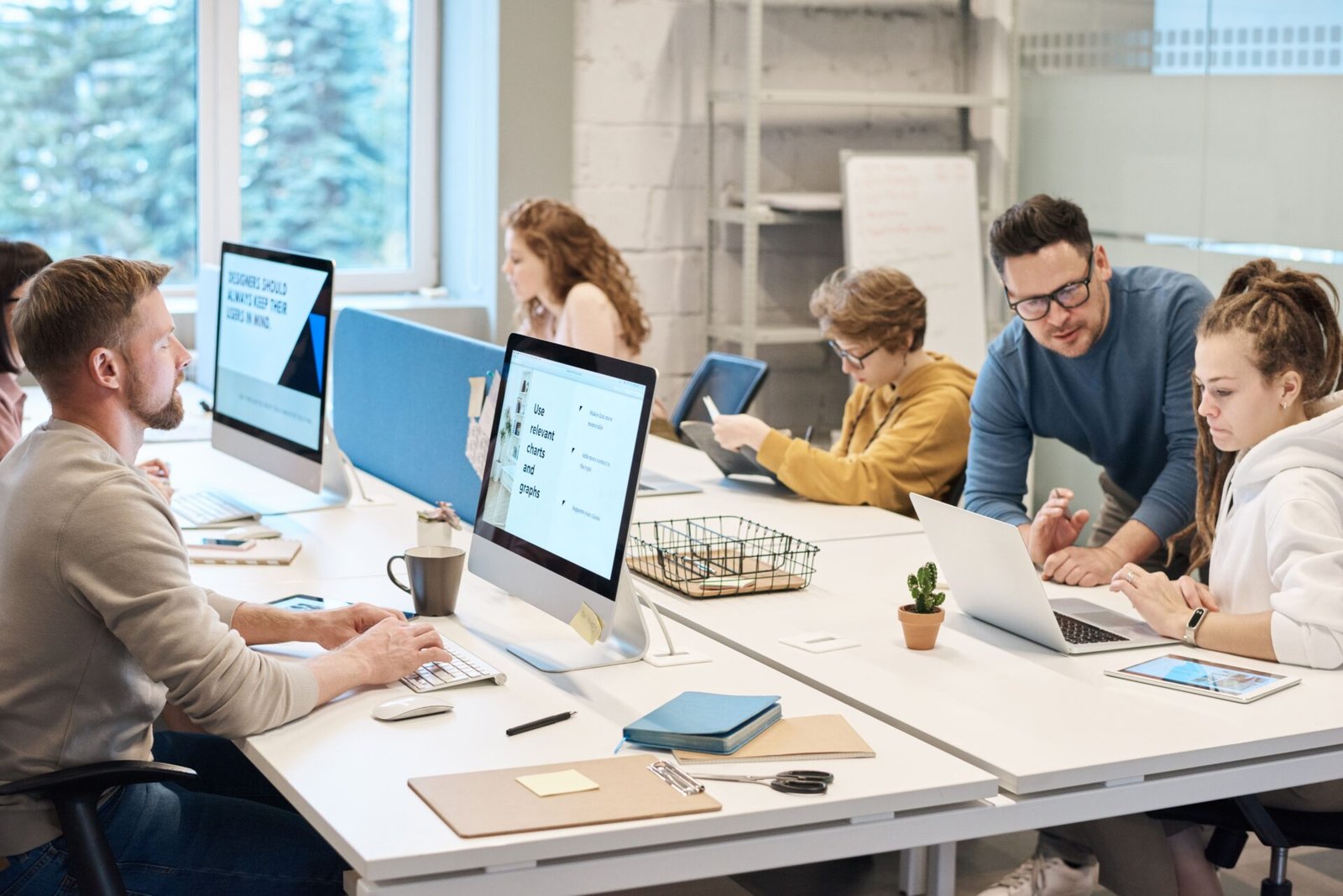 Team collaborating at a computer, discussing culture strategy